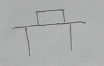Pencil sketch of a small box on a table top with two legs.