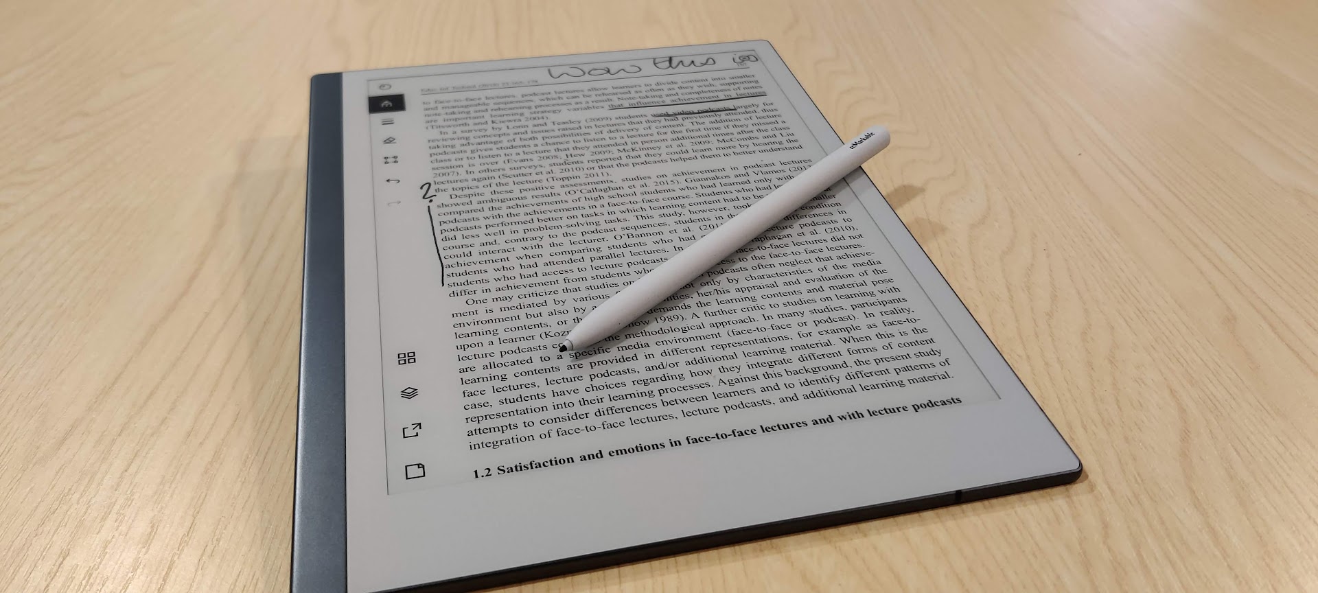 Photograph of a Remarkable tablet showing an annotated PDF, with a stylus resting on it.