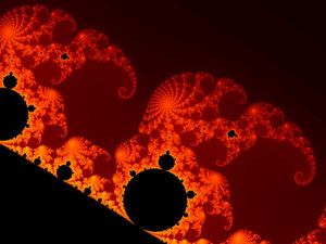 A fractal image in black, dark red and orange: a large black rounded shape on the lower left with smaller black bulbs along its edge and repeating spirals of orange and red filaments around them.