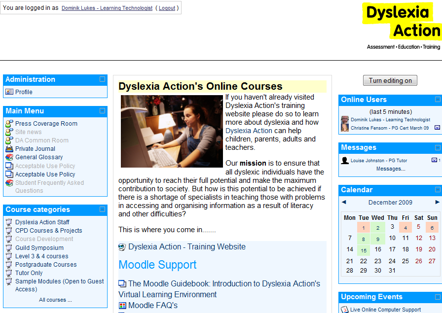 Screenshot of the Dyslexia Action online courses site in Moodle, logged in: a Main Menu and Course categories on the left, a welcome text beside a photo of a person at a computer in the centre, and Online Users and Calendar blocks on the right.