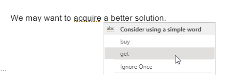 Screenshot of the sentence “We may want to acquire a better solution.” with a suggestion menu headed “Consider using a simple word” offering “buy” and “get”, and an “Ignore Once” option.