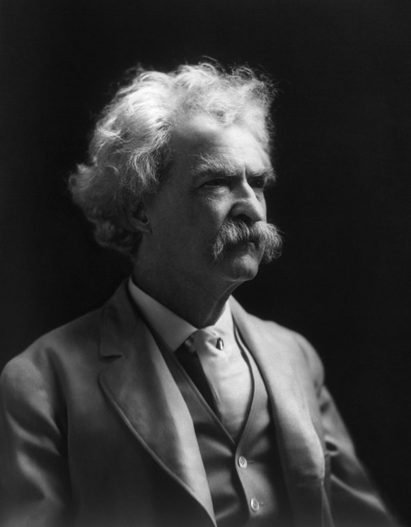 Black-and-white portrait photograph of Mark Twain, an older man with white hair and a moustache, wearing a suit.